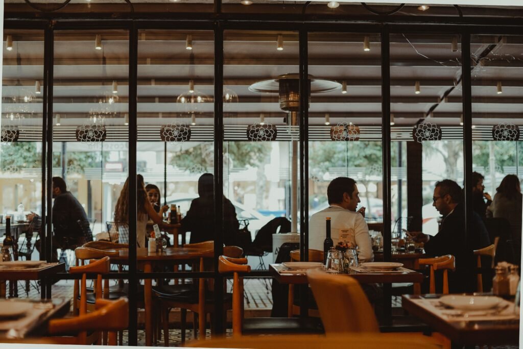 A bustling restaurant interior showcasing diners enjoying their meals in a cozy atmosphere.