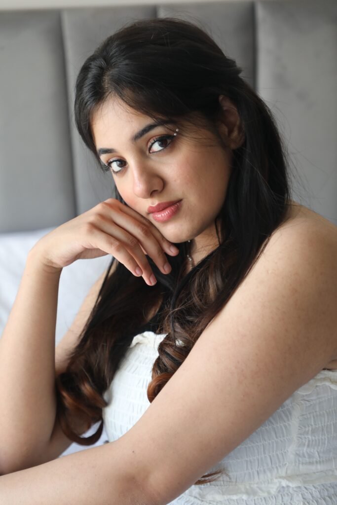 Elegant portrait of a woman with long hair, posing indoors with a gentle expression.